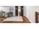 Hallway area with hardwood flooring, a decorative rug, and view of bedroom at 4455 Broadway St, Indianapolis, IN 46205