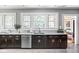 Updated kitchen with granite countertops, stainless steel dishwasher, and dark wood cabinetry at 4455 Broadway St, Indianapolis, IN 46205
