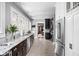 Spacious kitchen featuring granite countertops, stainless steel appliances, and dark wood cabinets at 4455 Broadway St, Indianapolis, IN 46205
