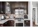 Kitchen featuring granite countertops, stainless steel appliances, and dark wood cabinets at 4455 Broadway St, Indianapolis, IN 46205