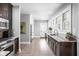 Long, open kitchen with stainless steel appliances, light gray walls, and dark wood cabinets at 4455 Broadway St, Indianapolis, IN 46205