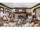 Cozy living room featuring a brick fireplace, built-in bookshelves, and comfortable seating at 4455 Broadway St, Indianapolis, IN 46205