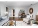 Bright living room featuring hardwood floors, a comfortable seating area, and a view of the office space at 4455 Broadway St, Indianapolis, IN 46205