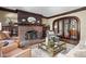 Elegant living room featuring a brick fireplace, dark wood trim, and stylish furnishings at 4455 Broadway St, Indianapolis, IN 46205