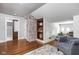 Charming living area boasts a brick accent wall, hardwood floors, built-in shelves, and a comfortable seating area at 4455 Broadway St, Indianapolis, IN 46205