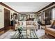 Open-concept living room with hardwood floors, elegant furniture, and detailed trim at 4455 Broadway St, Indianapolis, IN 46205