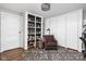 Cozy living room featuring built-in shelving and a comfortable brown armchair on a patterned rug at 4455 Broadway St, Indianapolis, IN 46205
