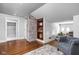 Charming living area boasts a brick accent wall, hardwood floors, built-in shelves, and a comfortable seating area at 4455 Broadway St, Indianapolis, IN 46205