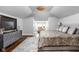 Elegant Primary bedroom features stylish decor, a comfortable bed, hardwood floors, and great natural light at 4455 Broadway St, Indianapolis, IN 46205