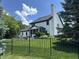 Well-maintained backyard featuring a large lawn, black fence, tall trees, and screened-in porch perfect for outdoor enjoyment at 4655 Rockcress Ct, Zionsville, IN 46077