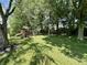 Backyard featuring a wooden playset, swing set, and lush green grass, perfect for Gathering fun at 4655 Rockcress Ct, Zionsville, IN 46077