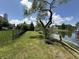 Picturesque backyard featuring lush green lawn, black metal fence, and a serene pond in the distance at 4655 Rockcress Ct, Zionsville, IN 46077