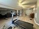 Finished basement with treadmill, piano, and staircase leading to the upper level at 4655 Rockcress Ct, Zionsville, IN 46077