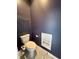 Powder room features a toilet and a shelf for storing bathroom supplies at 4655 Rockcress Ct, Zionsville, IN 46077
