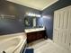 Bathroom with double vanity, a soaking tub, and good lighting at 4655 Rockcress Ct, Zionsville, IN 46077