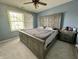 Relaxing bedroom featuring a queen bed, a ceiling fan, and natural light from a window at 4655 Rockcress Ct, Zionsville, IN 46077