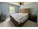 Cozy bedroom with a wooden platform bed, ceiling fan, and bright natural light at 4655 Rockcress Ct, Zionsville, IN 46077
