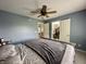 Bright bedroom showcasing neutral walls, a queen bed, ceiling fan, and closet at 4655 Rockcress Ct, Zionsville, IN 46077