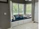 Bright breakfast nook features built-in bench seating with throw pillows and natural light at 4655 Rockcress Ct, Zionsville, IN 46077