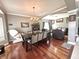 Open-concept dining area with hardwood floors, modern chandelier, and view into living space at 4655 Rockcress Ct, Zionsville, IN 46077