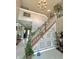Grand entryway with decorative staircase, chandelier, and tiled flooring for a luxurious welcome at 4655 Rockcress Ct, Zionsville, IN 46077
