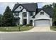 Charming two-story white brick home with green trim, two-car garage, and well-maintained lawn at 4655 Rockcress Ct, Zionsville, IN 46077