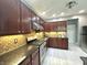 This kitchen features granite counters, stainless appliances, and tile backsplash at 4655 Rockcress Ct, Zionsville, IN 46077