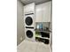 Efficient laundry area features stacked washer/dryer, custom cabinets, and countertop space at 4655 Rockcress Ct, Zionsville, IN 46077