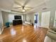 Spacious living room with hardwood floors, ceiling fan, and TV console at 4655 Rockcress Ct, Zionsville, IN 46077
