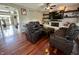 Spacious living room featuring hardwood floors, a fireplace and plush leather seating at 4655 Rockcress Ct, Zionsville, IN 46077