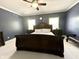 A bedroom with a large bed and two windows overlooking the yard at 4655 Rockcress Ct, Zionsville, IN 46077