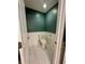 Charming powder room with white wainscoting, white tile floor and dark green paint at 4655 Rockcress Ct, Zionsville, IN 46077