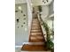 Staircase featuring wood steps, white railings, and green plants at 4655 Rockcress Ct, Zionsville, IN 46077