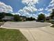 Neighborhood street showcasing various well-maintained homes under a vibrant blue sky with scattered clouds at 4655 Rockcress Ct, Zionsville, IN 46077