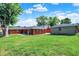 A spacious backyard with a brick house and a detached garage provides a great space for outdoor activities and relaxation at 5015 Nowland Ave, Indianapolis, IN 46201