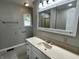 Bathroom features a vanity, mirror, window, and tile flooring at 5015 Nowland Ave, Indianapolis, IN 46201