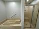 Bathroom features a bathtub, shower, and neutral paint at 5015 Nowland Ave, Indianapolis, IN 46201