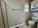 Bathroom features a toilet, shower, window, and storage at 5015 Nowland Ave, Indianapolis, IN 46201