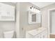 This bathroom includes a white vanity, mirror, and toilet at 5015 Nowland Ave, Indianapolis, IN 46201