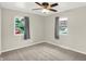This bedroom features carpeted floors and two windows with curtains at 5015 Nowland Ave, Indianapolis, IN 46201