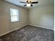 Cozy bedroom features neutral paint, carpet, and window with blinds at 5015 Nowland Ave, Indianapolis, IN 46201