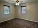 Carpeted bedroom with two windows at 5015 Nowland Ave, Indianapolis, IN 46201