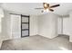 Carpeted bedroom with decorative sliding door and neutral walls at 5015 Nowland Ave, Indianapolis, IN 46201