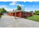 Side view of brick home with driveway leading to detached garage and covered entry at 5015 Nowland Ave, Indianapolis, IN 46201