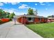 Side view of brick house with driveway leading to detached garage and covered entry at 5015 Nowland Ave, Indianapolis, IN 46201