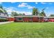 Charming brick home with a well-maintained lawn and mature trees on a sunny day at 5015 Nowland Ave, Indianapolis, IN 46201