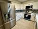 Well-lit kitchen with stainless steel appliances, white cabinetry, and durable countertops at 5015 Nowland Ave, Indianapolis, IN 46201