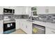 Beautiful kitchen featuring modern appliances, stainless steel dishwasher, and sleek faucet fixtures at 5015 Nowland Ave, Indianapolis, IN 46201