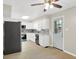Bright kitchen featuring white cabinets, stainless steel appliances, stylish backsplash, and a door leading to the backyard at 5015 Nowland Ave, Indianapolis, IN 46201