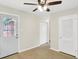 Bright living room with wood-look floors and ceiling fan near the entry door at 5015 Nowland Ave, Indianapolis, IN 46201